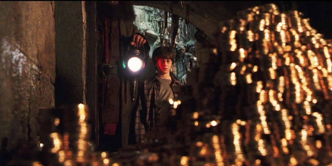 Harry Potter looking at piles of gold coins inside Gringotts Vault in the Harry Potter film series.