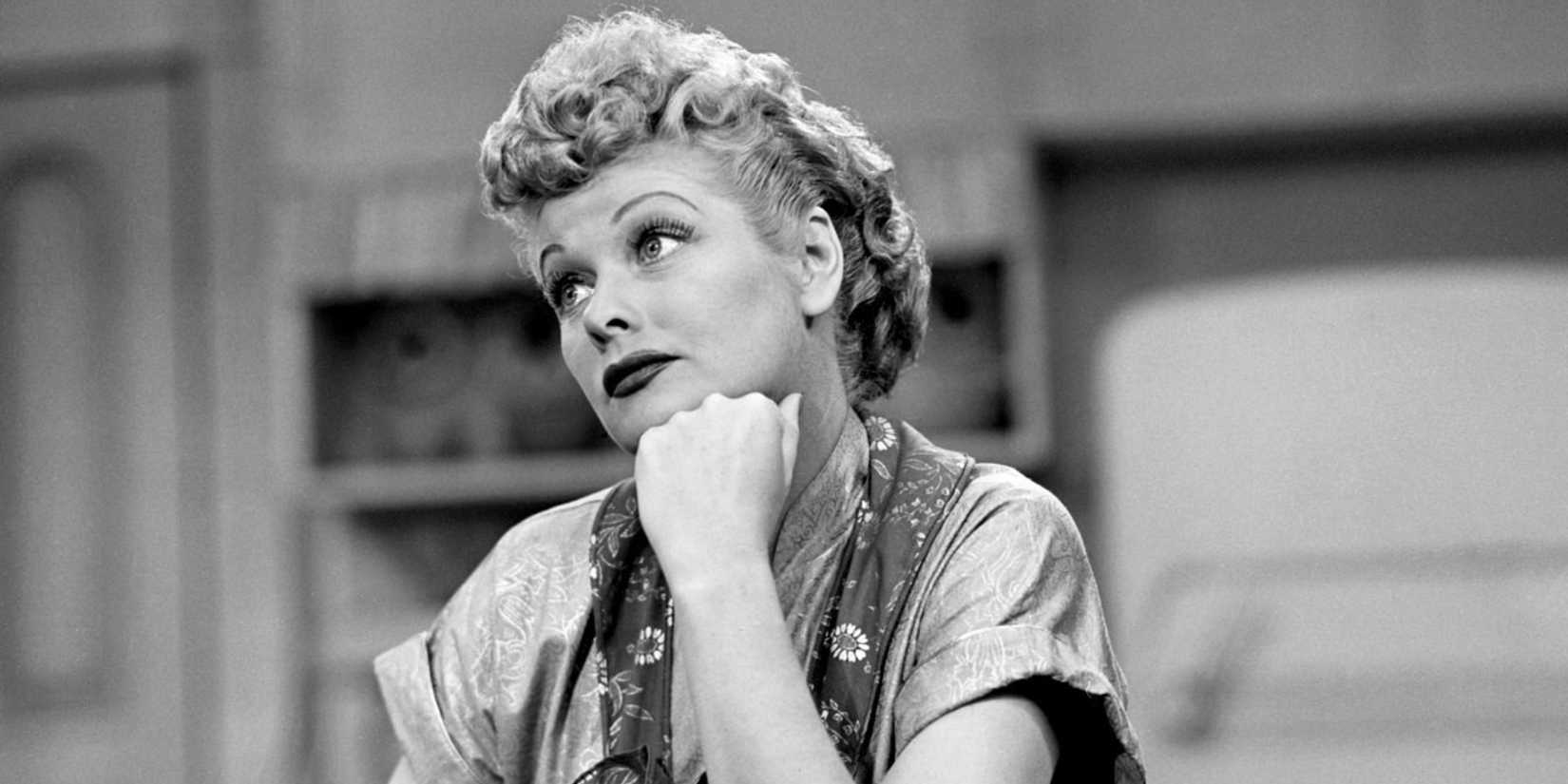 Lucille Ball resting her head on her hand and thinking in I Love Lucy.