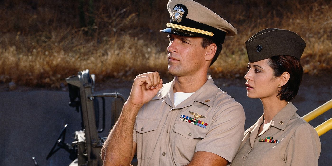 Harmon Rabb (David James Elliott) and Sarah MacKenzie (Catherine Bell) in uniform and looking off camera on 'JAG'
