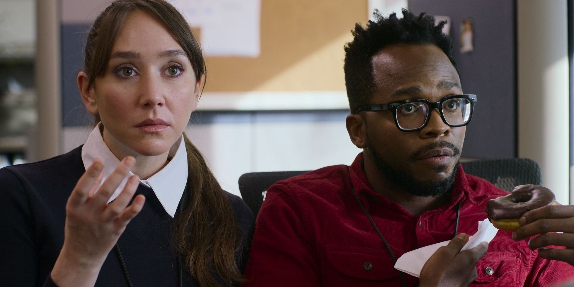 Susan and Patrick, played by actors Patty Guggenheim and Kenneth Mosley, sit in an office caught off-guard in Don't Tell Larry.