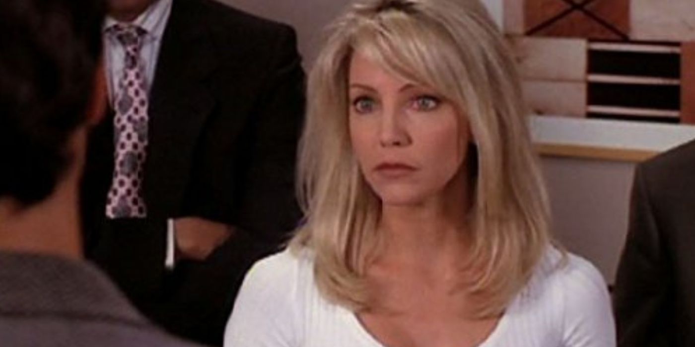 Heather Locklear as Amanda Woodward talking to someone with their back to the camera on Melrose Place.