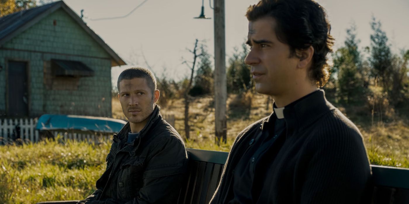 Hamish Linklater and Zach Gilford sit on a bench outside in Mike Flanagan's Midnight Mass on Netflix.