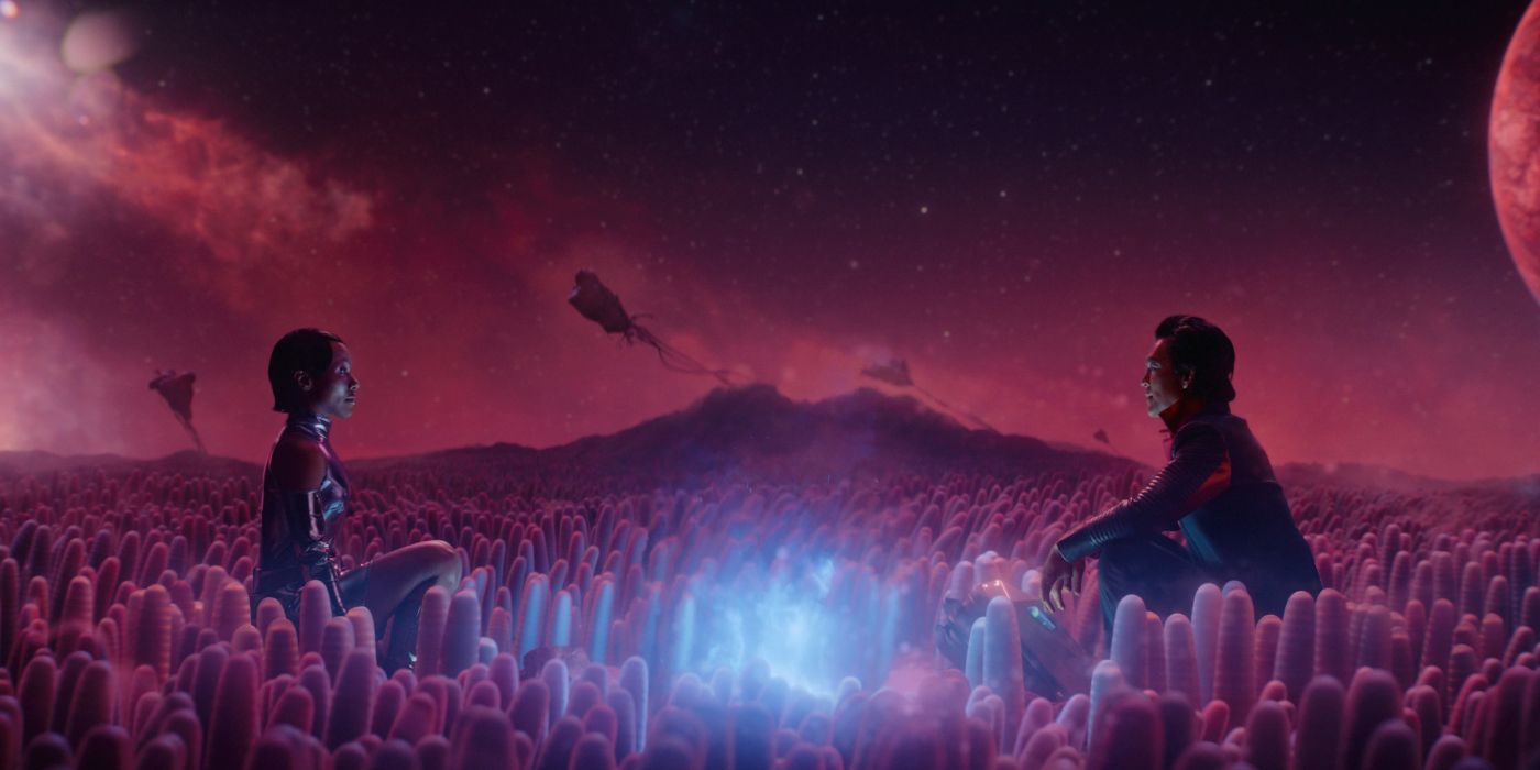 John Cho and DeWanda Wise sit in a field in Murderbot's Sanctuary Moon series