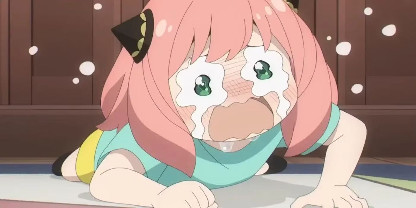 A sad Anya Forger cries while lying on the floor in Spy x Family.