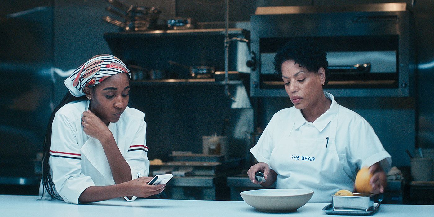 Syd (Ayo Edebiri) working at the kitchen station next to Tina (Liza Colón-Zayas) in The Bear Season 4