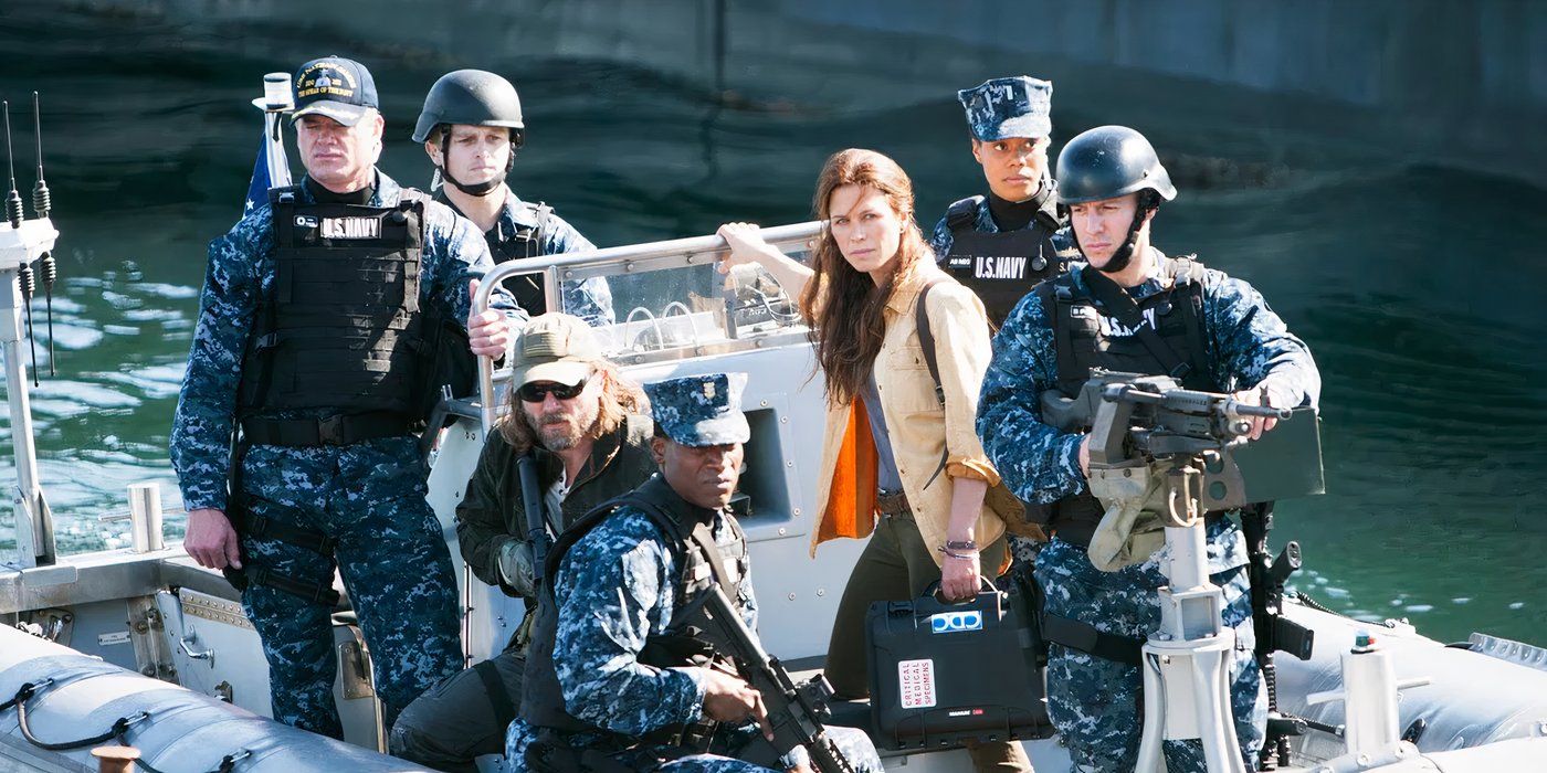 The cast of The Last Ship on a small boat heading somewhere with serious expressions.
