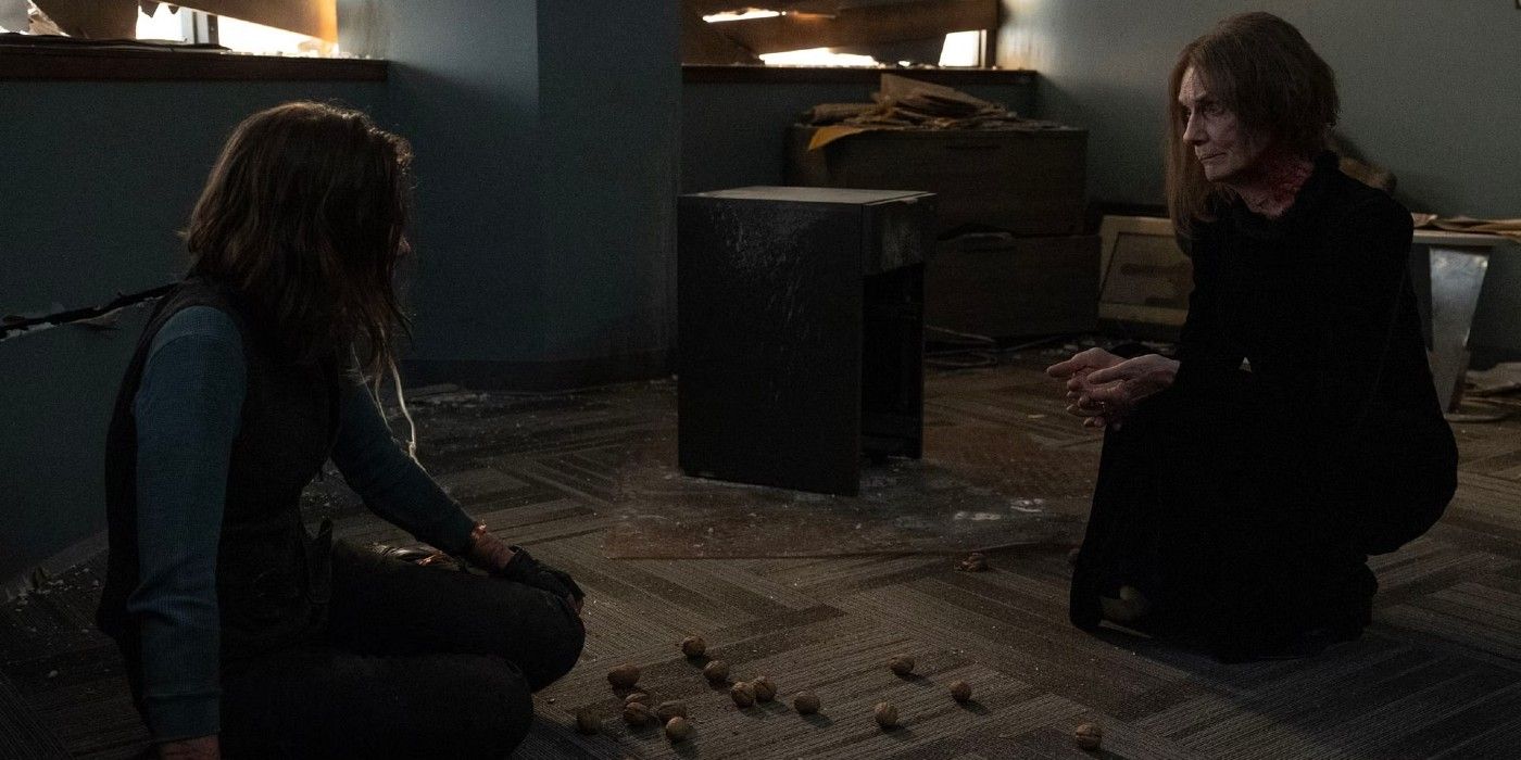 Lisa Emery as The Dama kneels next to a restrained Lauren Cohan as Maggie in 'The Walking Dead: Dead City'
