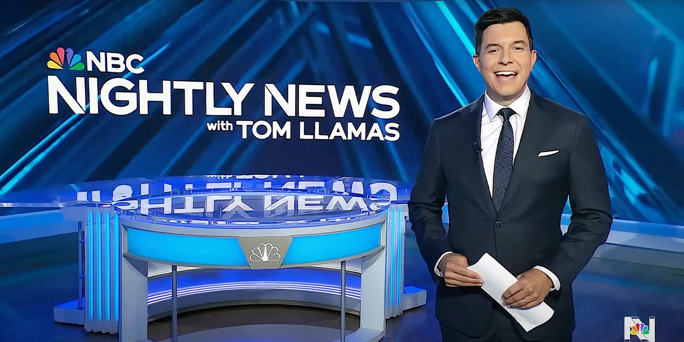 Tom Llamas standing in front of and to the side of the NBC Nightly News desk