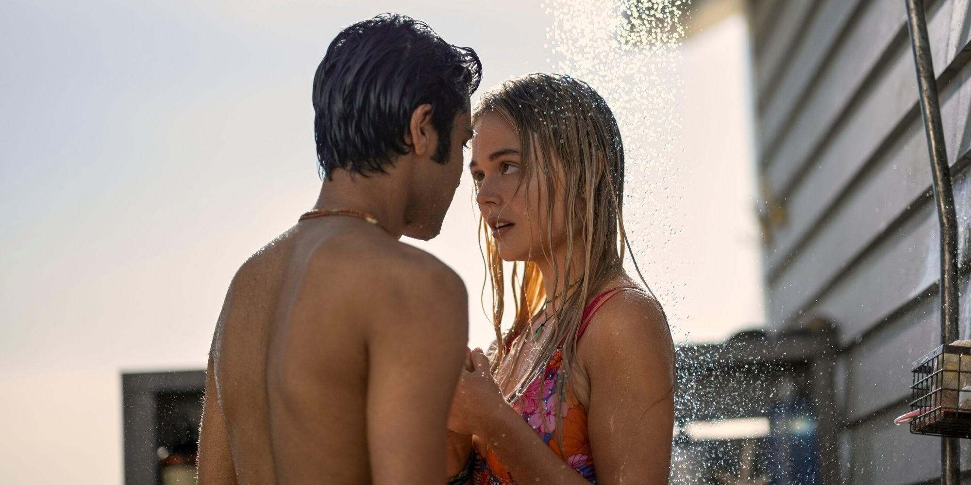 Emily Alyn Lind as Cadence standing under the outdoor shower with Shubham Maheshwari as Gat in We Were Liars