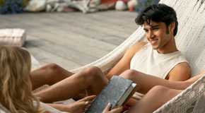 Emily Alyn Lind as Cadence sharing a hammock with Shubham Maheshwari as Gat in We Were Liars