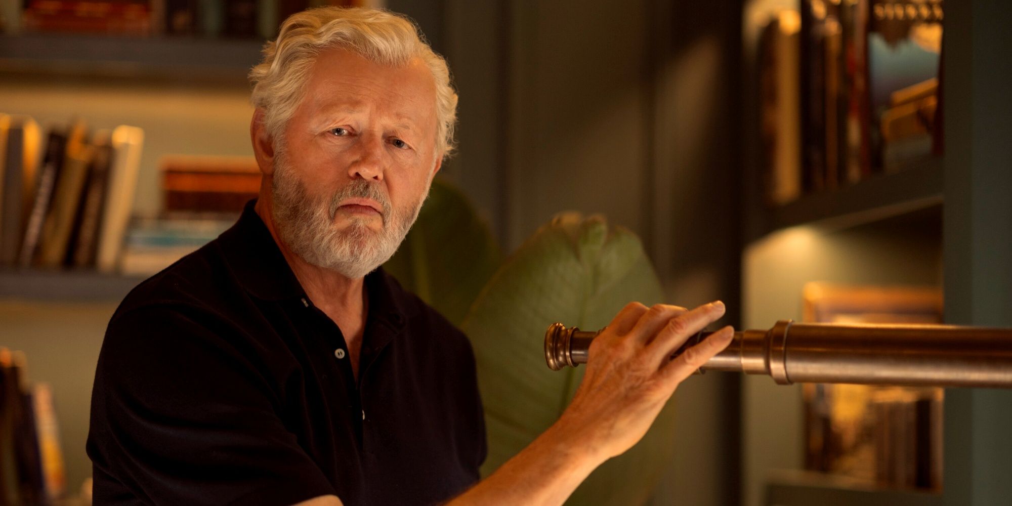 David Morse as Harris Sinclair holding a telescope while looking toward the camera in We Were Liars