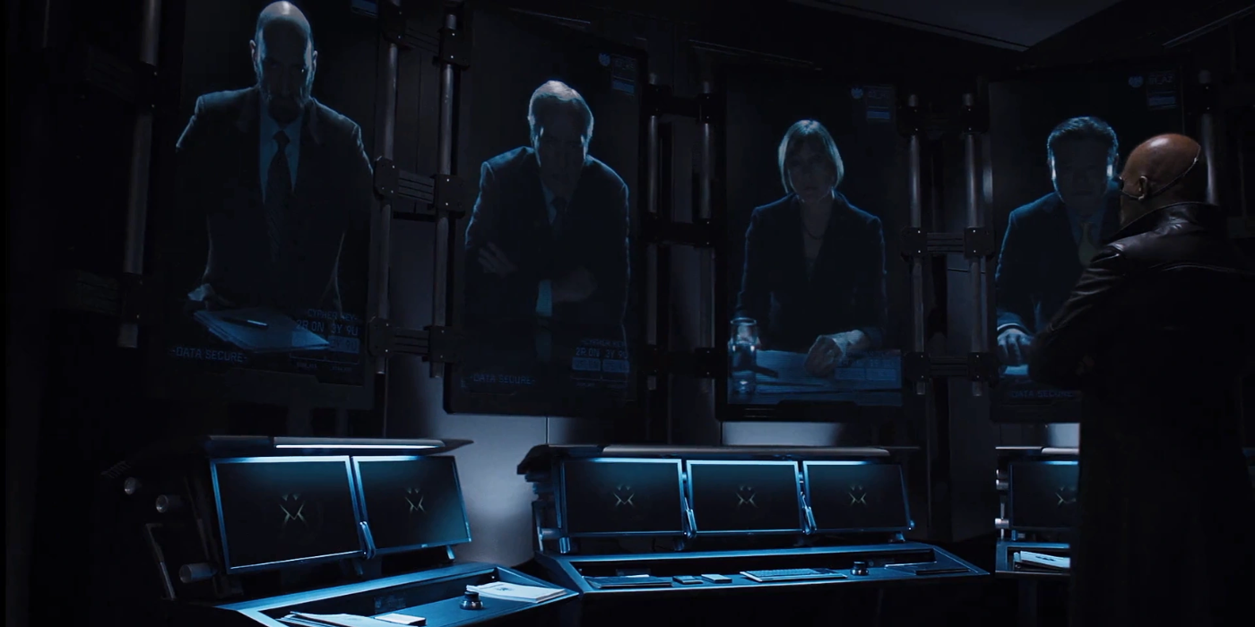 Nick Fury looks at ominously lit World Security Council members on big screens in The Avengers.