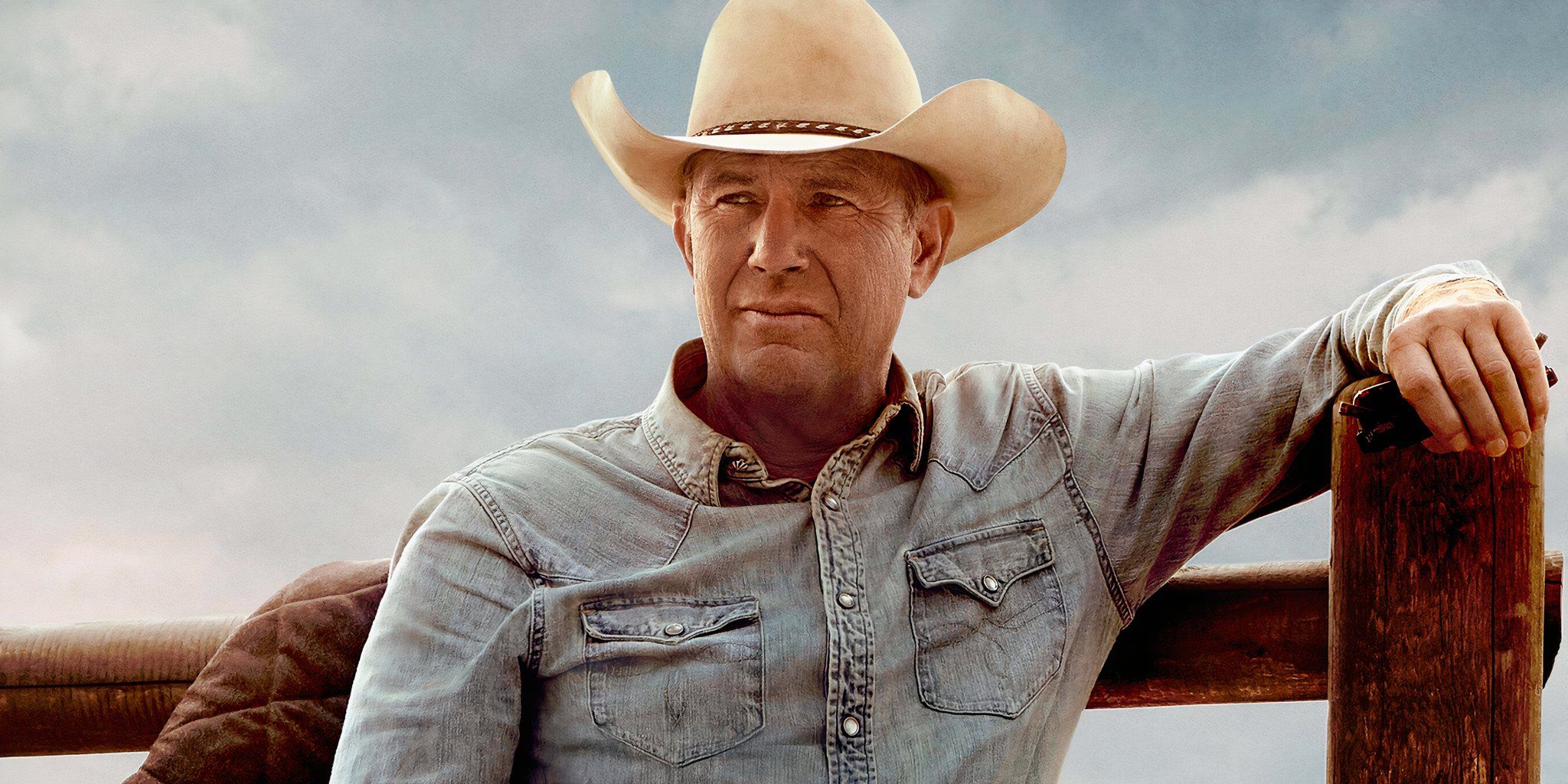 Kevin Costner leaning against a fence in Yellowstone