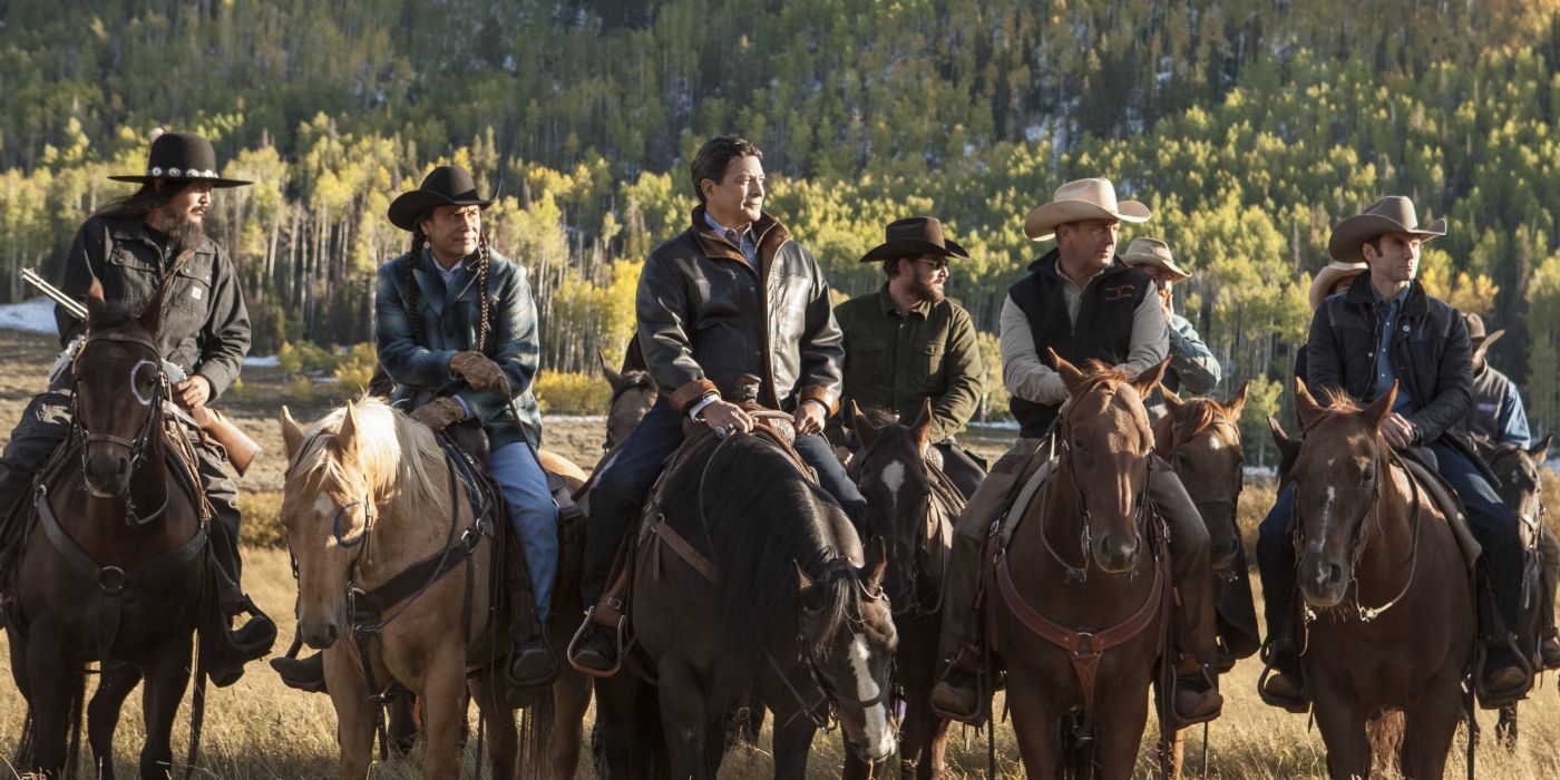 The cast of Yellowstone season 1, episode 1, "Daybreak" sit on horses and look at something off-screen.