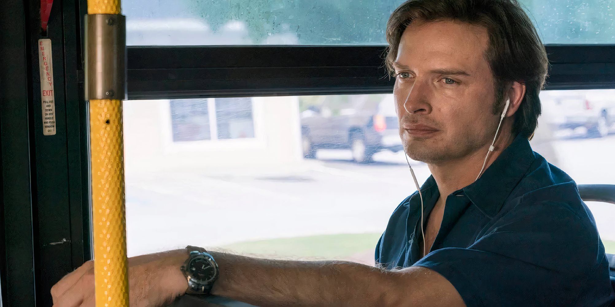 Aden Young as Daniel Holden in Rectify sat inside a bus with earpods in.