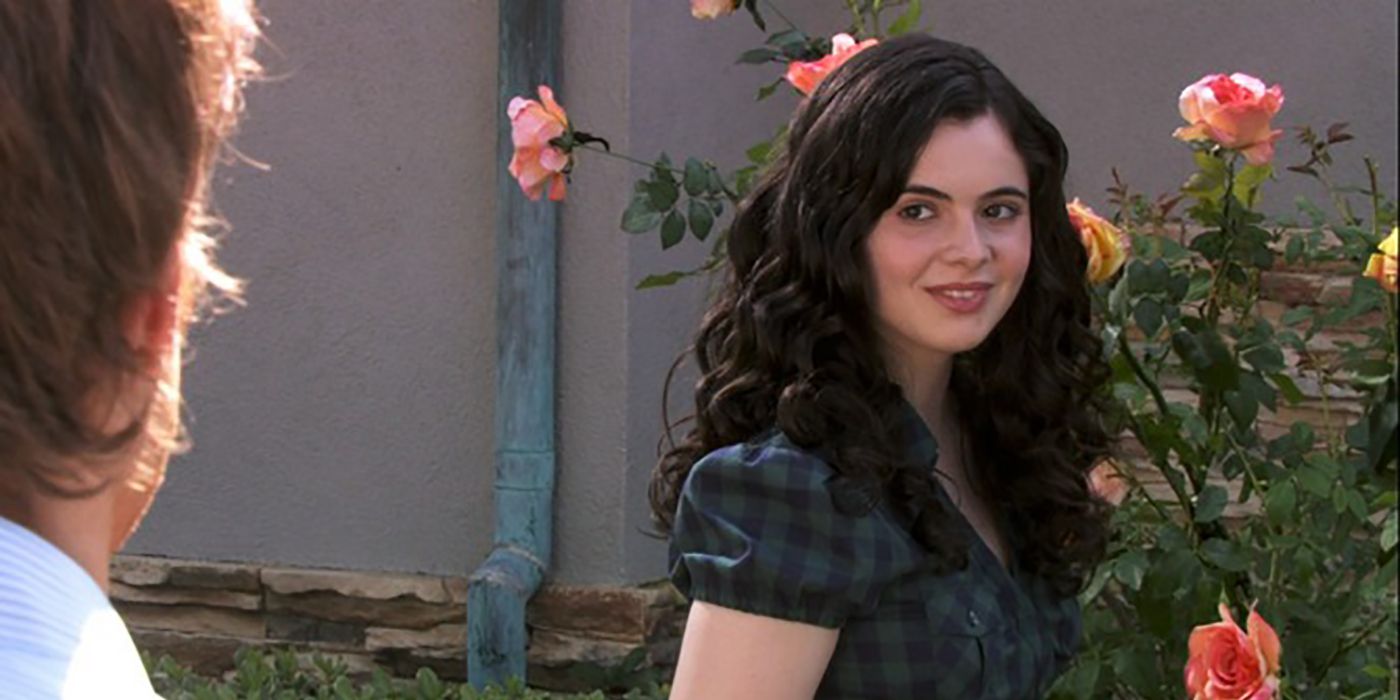 Rebecca Mitchell outside by a rose bush smiling at Dexter in the series Dexter.