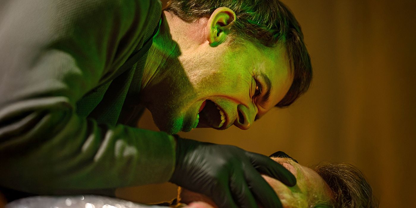 Dexter (Michael C. Hall) reaches out to someone while wearing gloves in 'Dexter: Resurrection.'