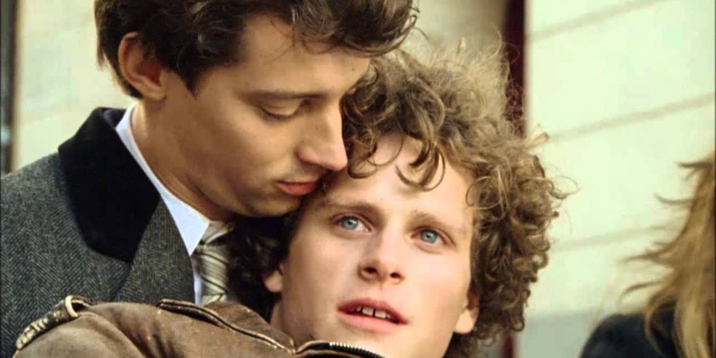 Two men embracing in Don't Ever Wipe Tears Without Gloves