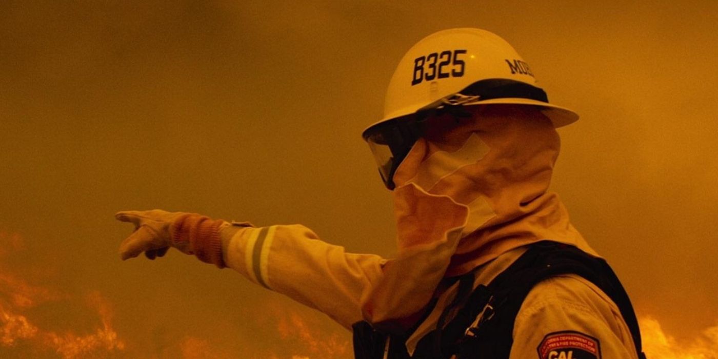 A still from Netflix documentary Fire Chasers showing a firefighter standing near a wildfire.