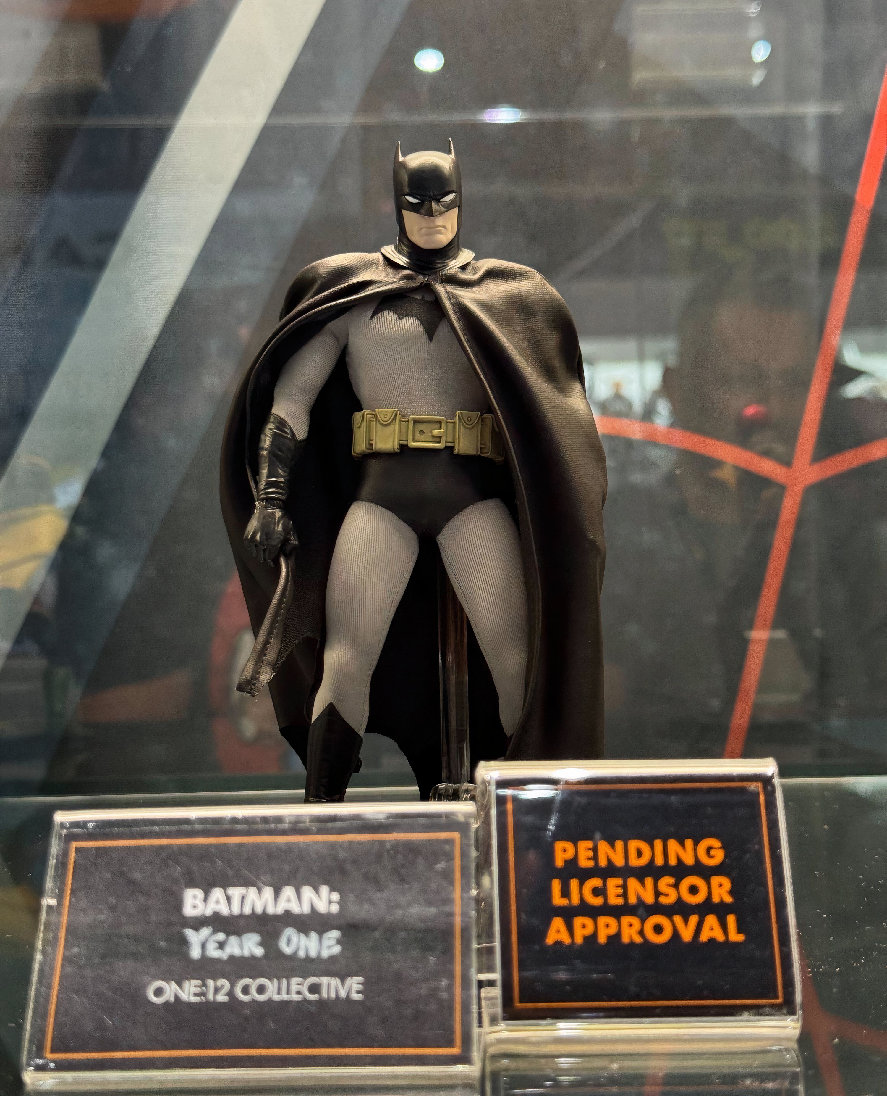Mezco Toyz' figure of Batman Year One holding a weapon at his side