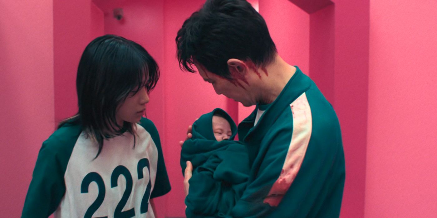 Jun-hee (Jo Yu-ri) trusts Gi-hun (Lee Jung-jae) to carry her baby in Squid Game Season 3.
