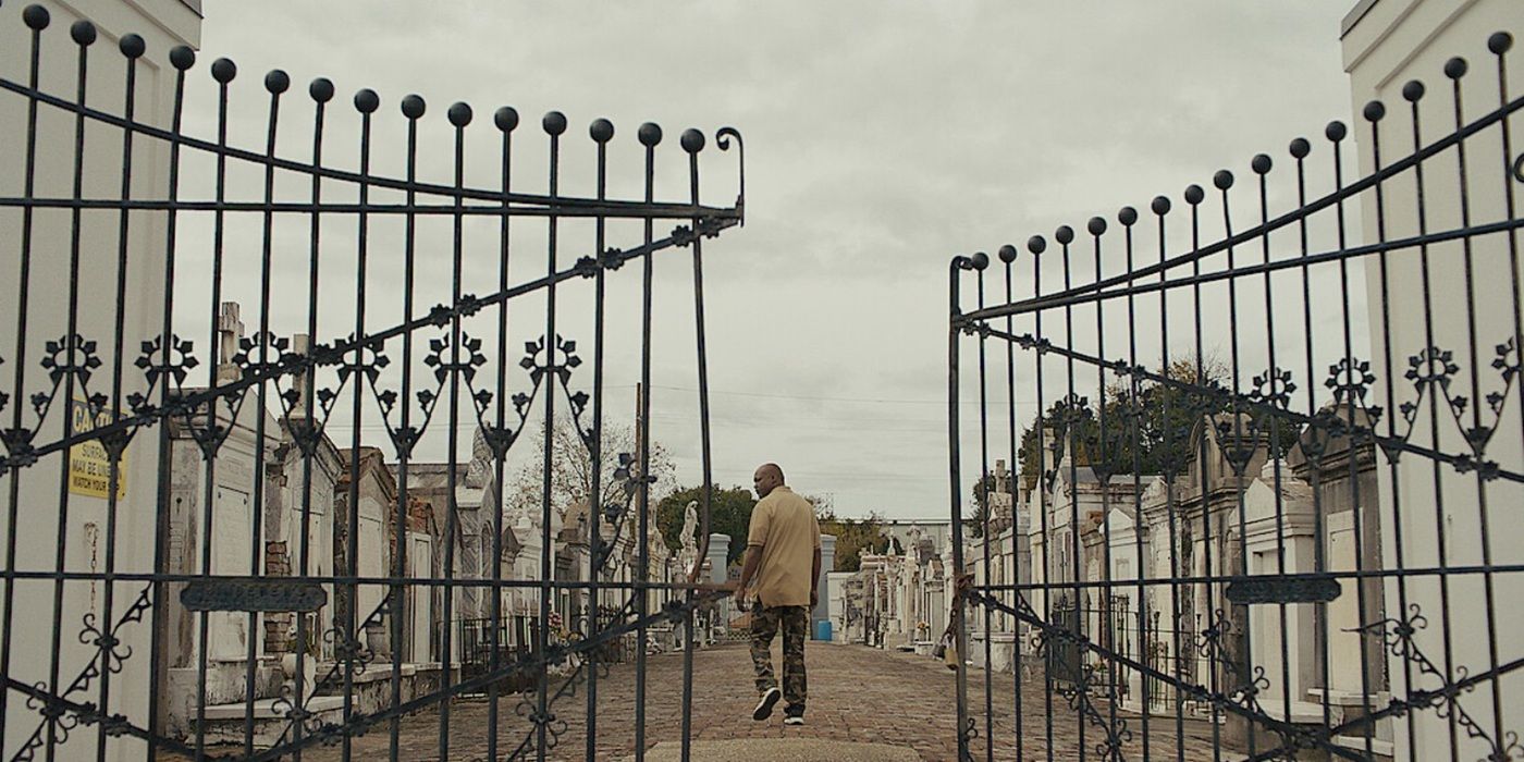 A person walks through an above-ground cemetery in the Katrina: Come Hell and High Water documentary.