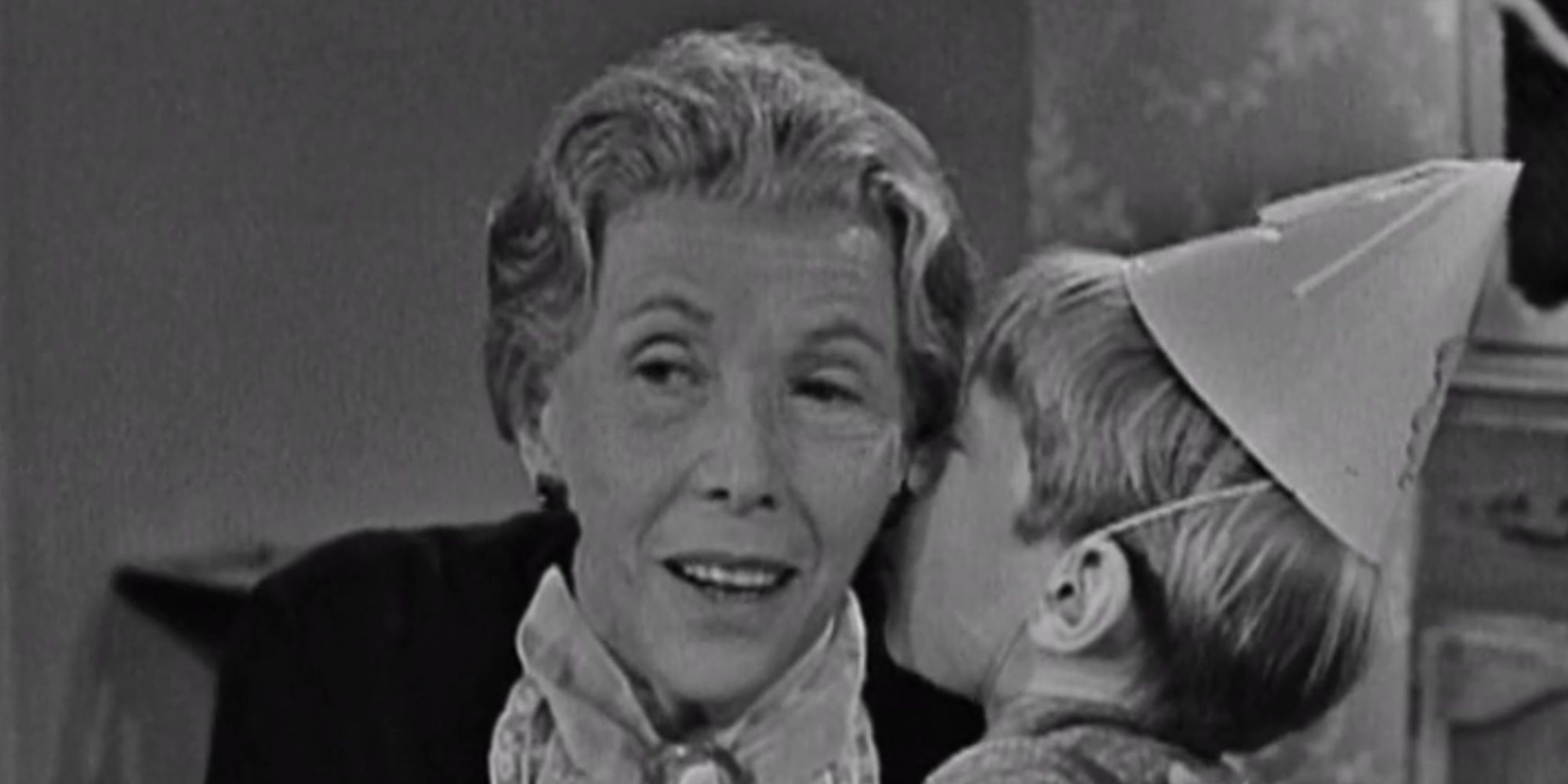 Billy (Bill Mumy) whispers a secret wish to his grandma (Lili Darvas) on The Twilight Zone.