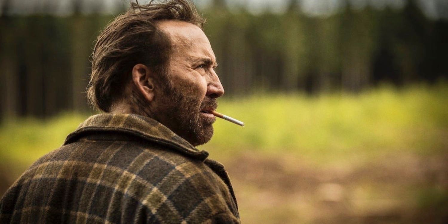 Nicolas Cage standing outside with a cigarette in his mouth near the start of Mandy (2018)