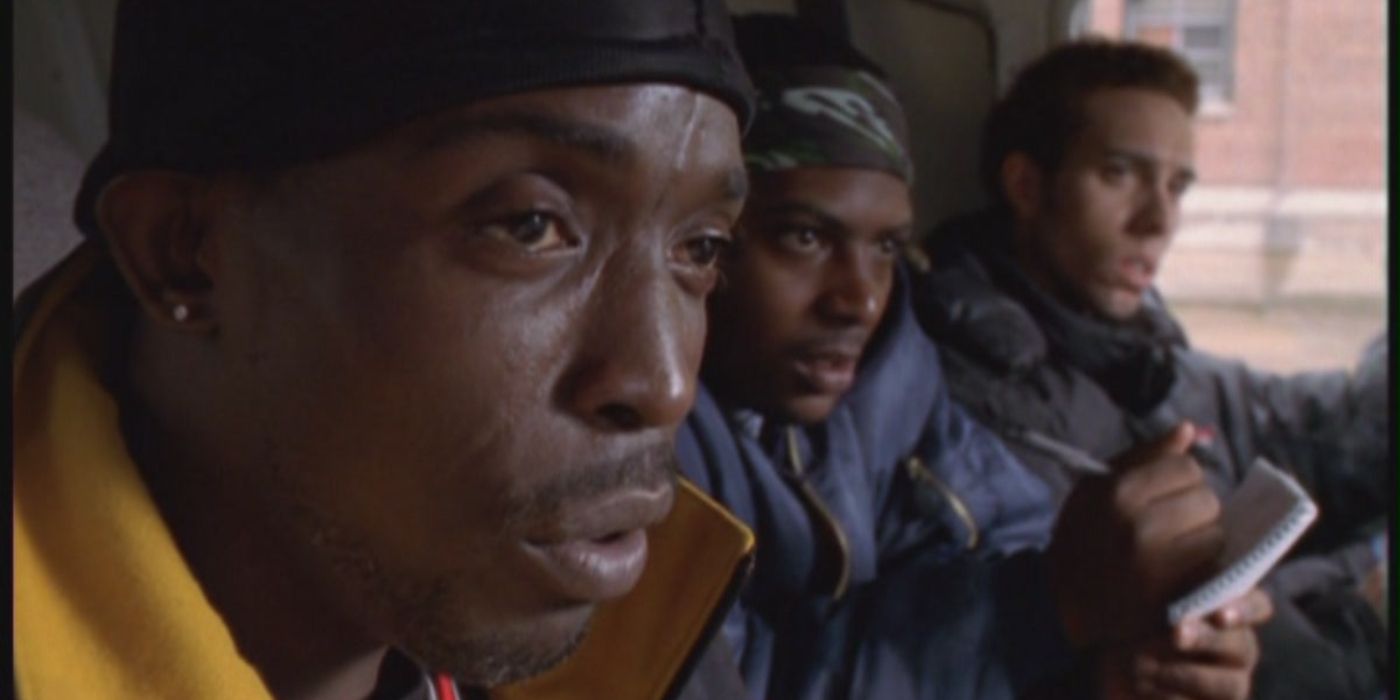 Omar in the van with his gangster friends staking out someone off-screen in The Wire