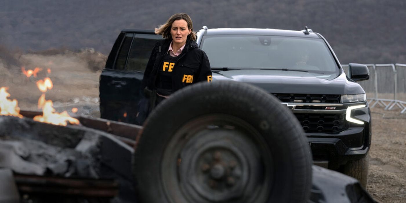 Taylor Schilling as Agent Annie Milligan looking at a wrecked car in 'Poker Face' Season 2.