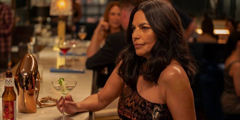 Sarita Choudhury, holding a cocktail, as Seema in And Just Like That... Season 3