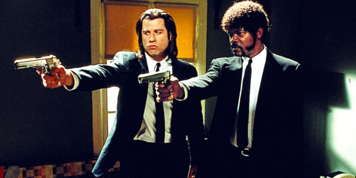 John Travolta and Samuel L. Jackson as Vincent Vega and Jules Winnfield wearing black suits and holding a gun in 'Pulp Fiction'