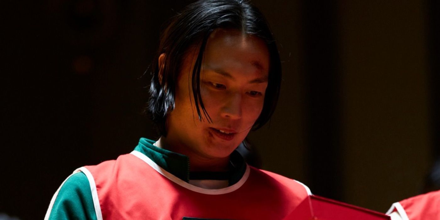 Nam-gyu looks at the dagger for Hide and Seek in Squid Game.