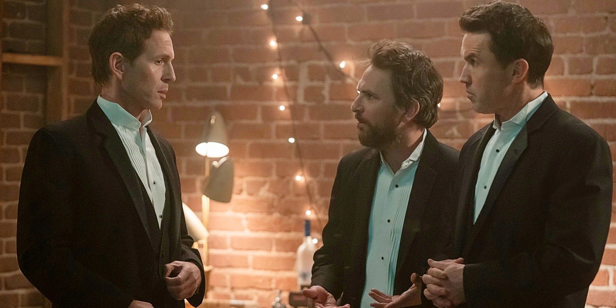 Dennis Reynolds, Charlie Kelly, and Mac McDonald dressed in tuxedos at a gala in It's Always Sunny in Philadelphia Season 17.