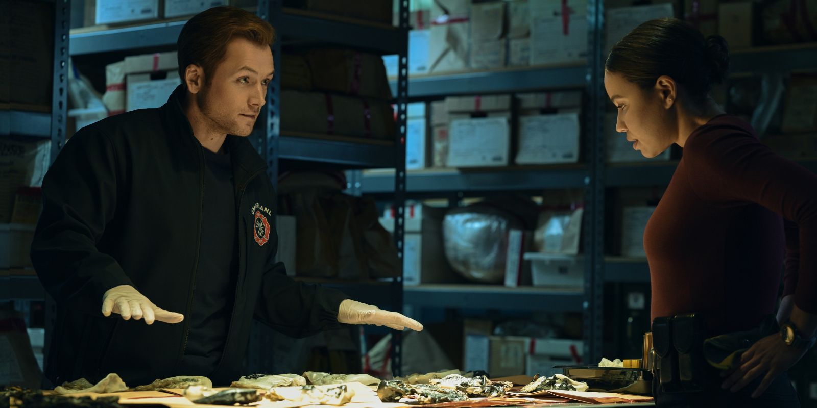 Taron Egerton and Jurnee Smollett talking in Smoke
