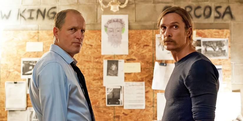 Woody Harrelson and Matthew McConaughey in front of a board with drawings and photos in True Detective.