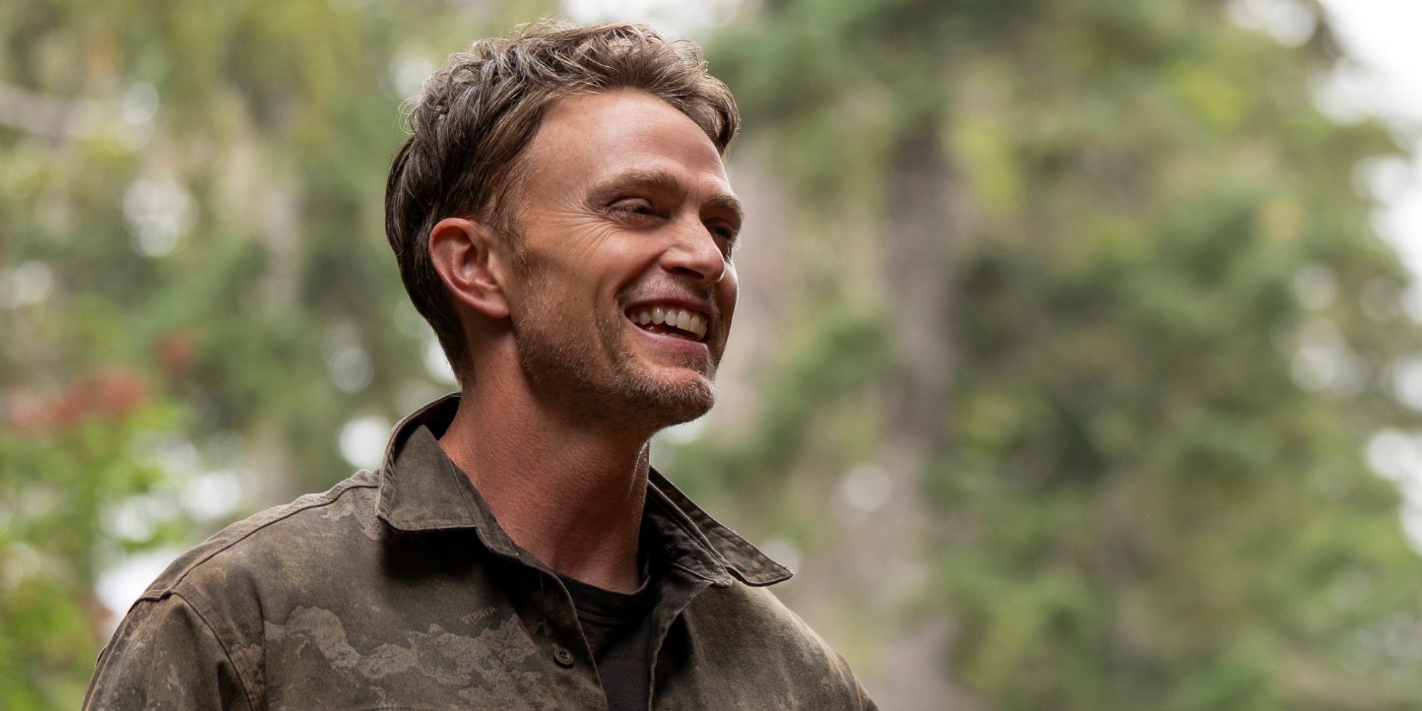 Wilson Bethel as Shane Maguire out among the trees in the wilderness in Netflix's Untamed