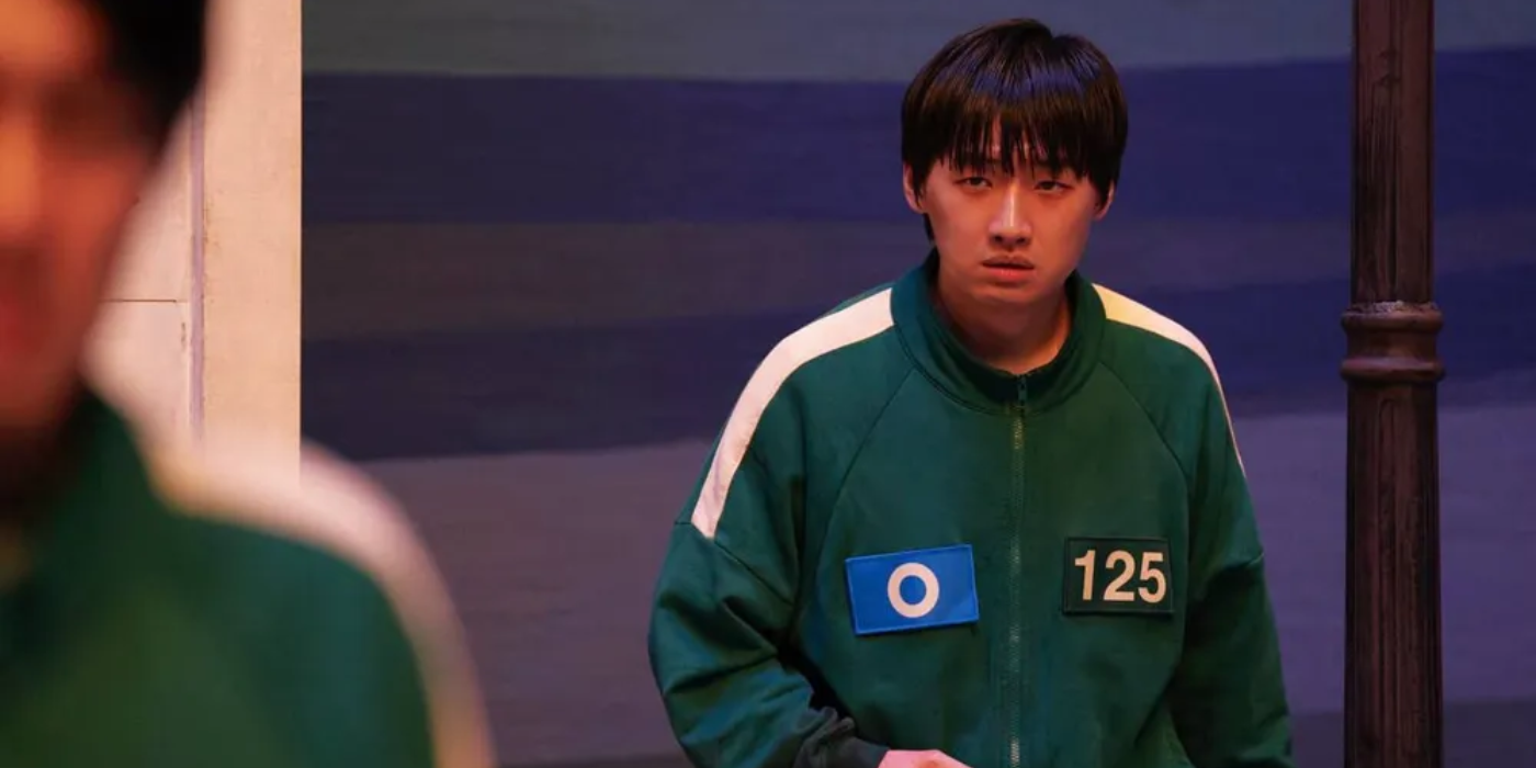 Min-su looks anxiously in Squid Game.