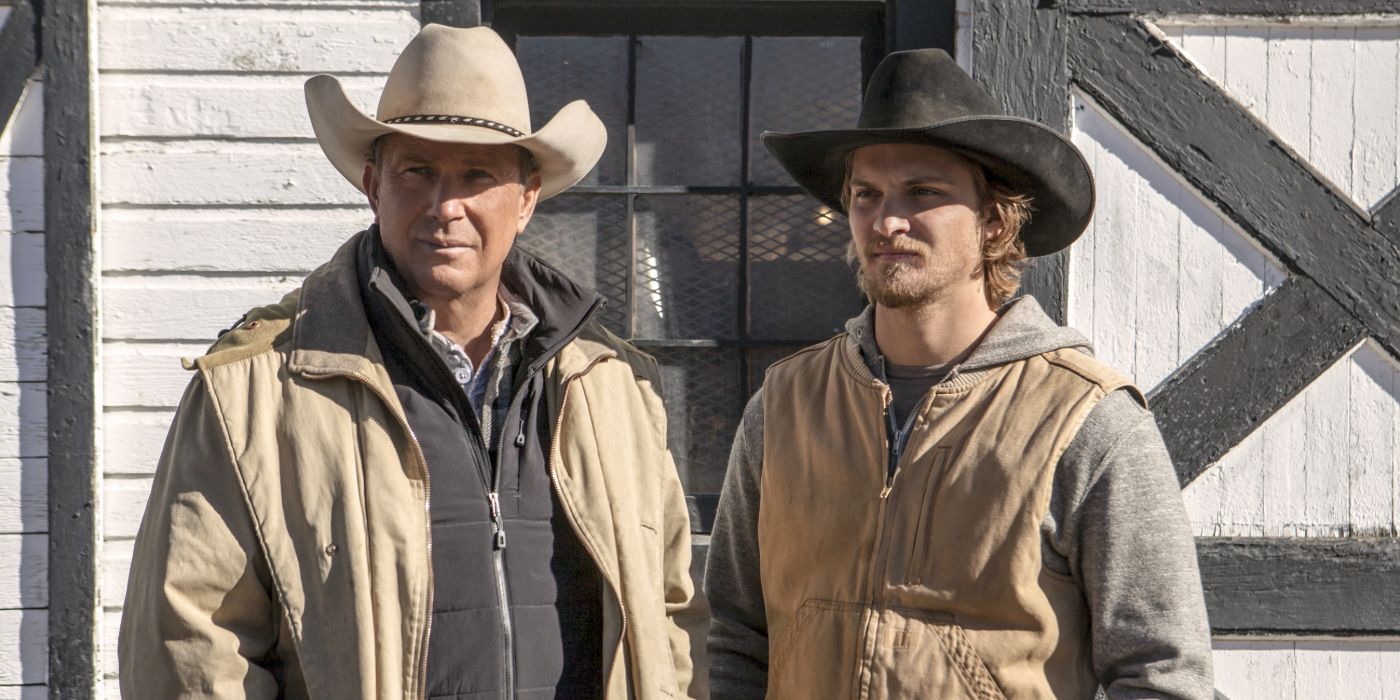 Kevin Costner and Luke Grimes standing in front of a barn in Yellowstone, Coming Home.