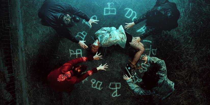 A possessed male lies in a circle on demonology symbols in Cracow Monsters.