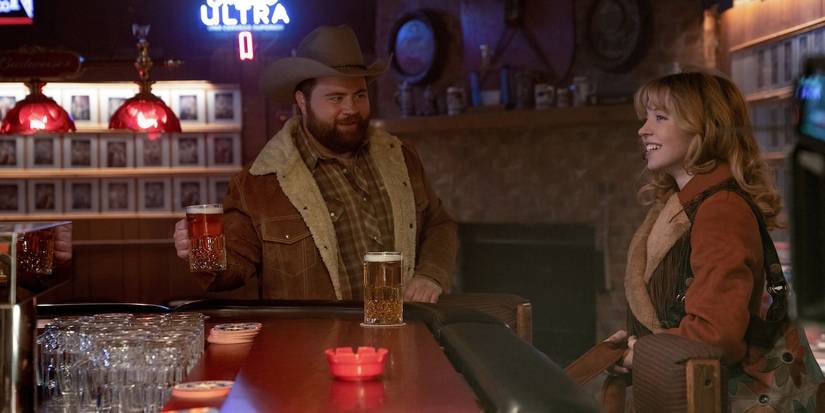 Paul Walter Hauser and Sydney Sweeney in a bar in Americana