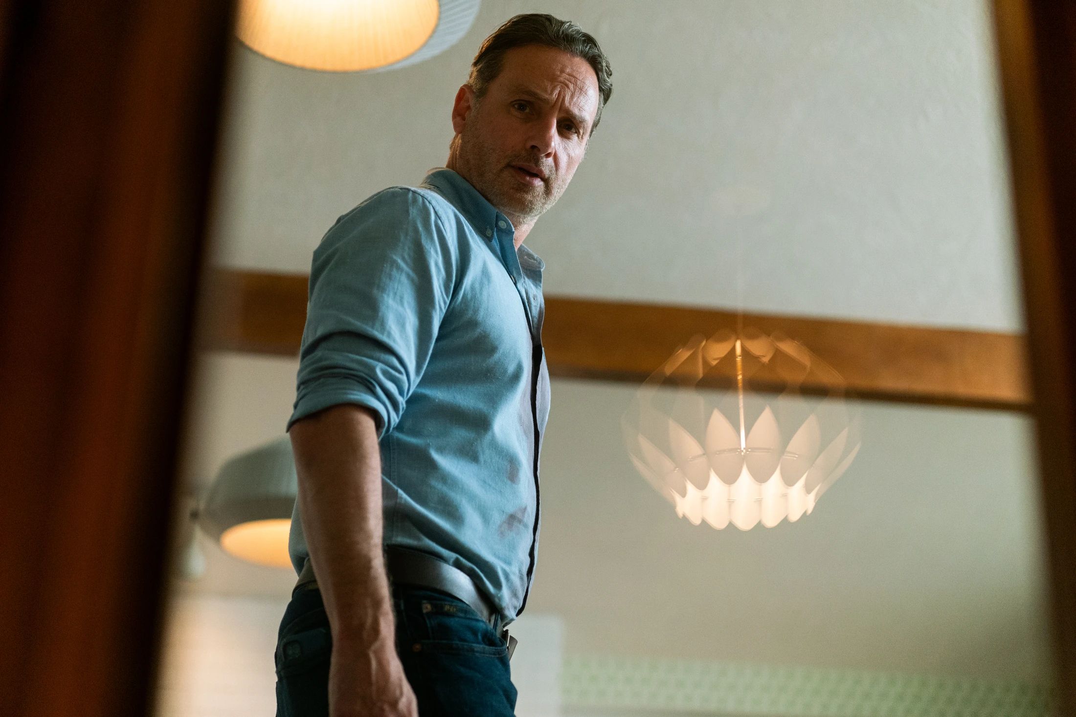 Andrew Lincoln looking worried in the mirror in Coldwater