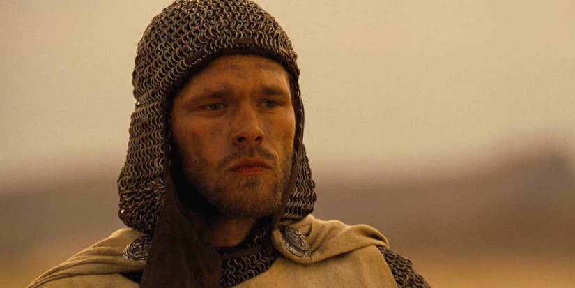 Joakim Nätterqvist as Arn Magnussun with a chainmail headpiece and dirtied face looks ahead in Arn.