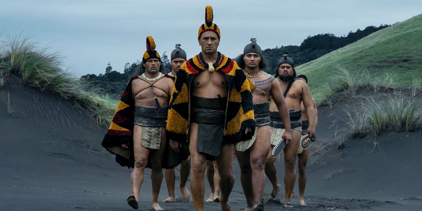 Cliff Curtis leading warriors across a beach in Chief of War