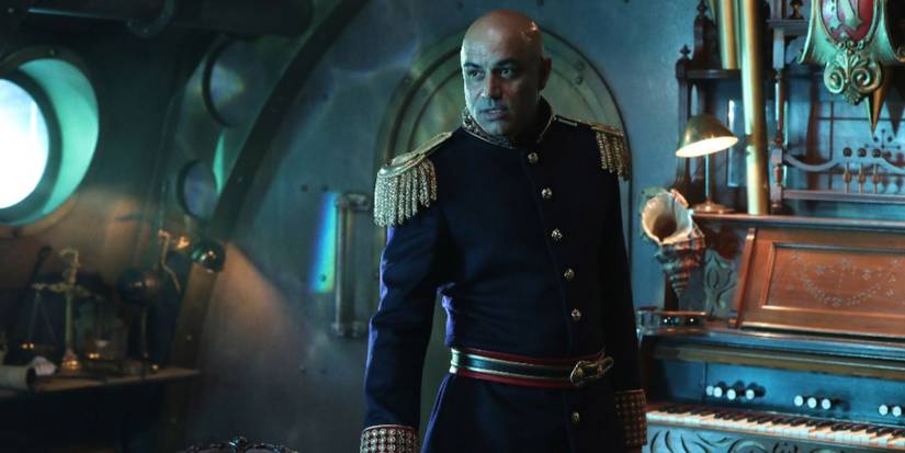 Faran Tahir as Captain Nemo in uniform on a ship talking to someone off camera in Once Upon a Time.