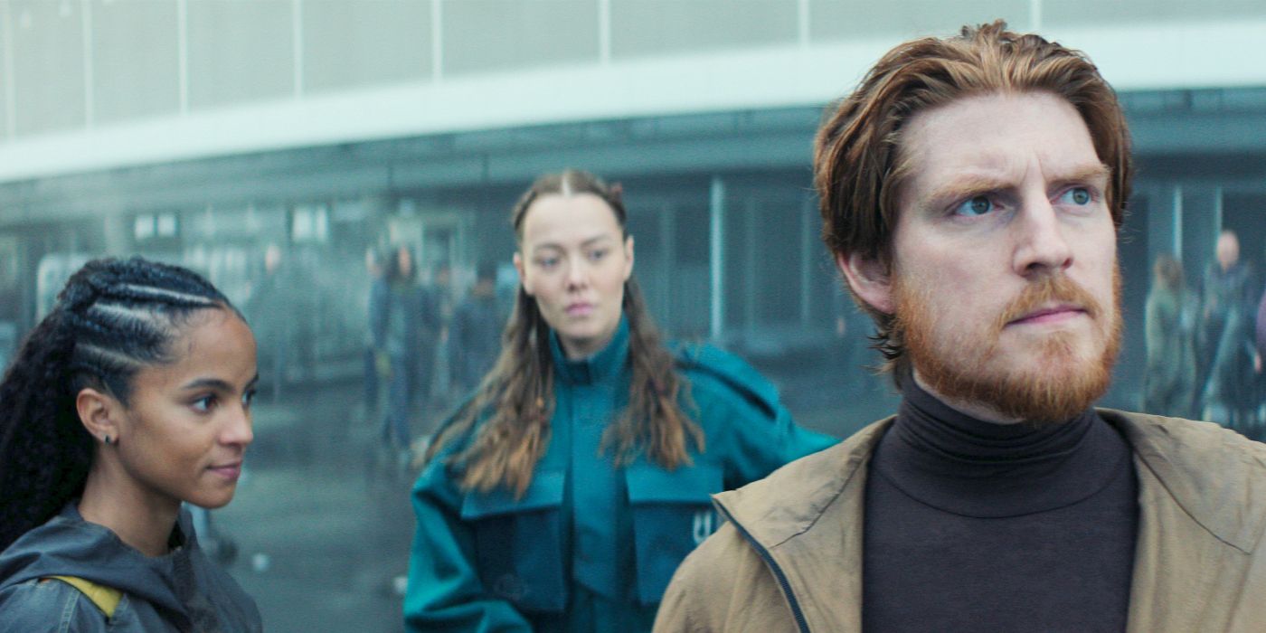 Gaal Dornick standing with a man and a woman outside a building in Foundation Season 3 Episode 5