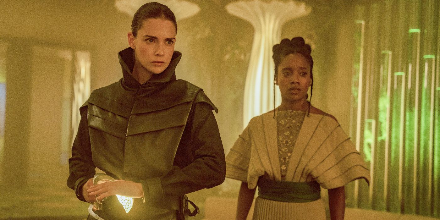 Song standing next to an armed woman wearing a black coat in Foundation Season 3 Episode 6
