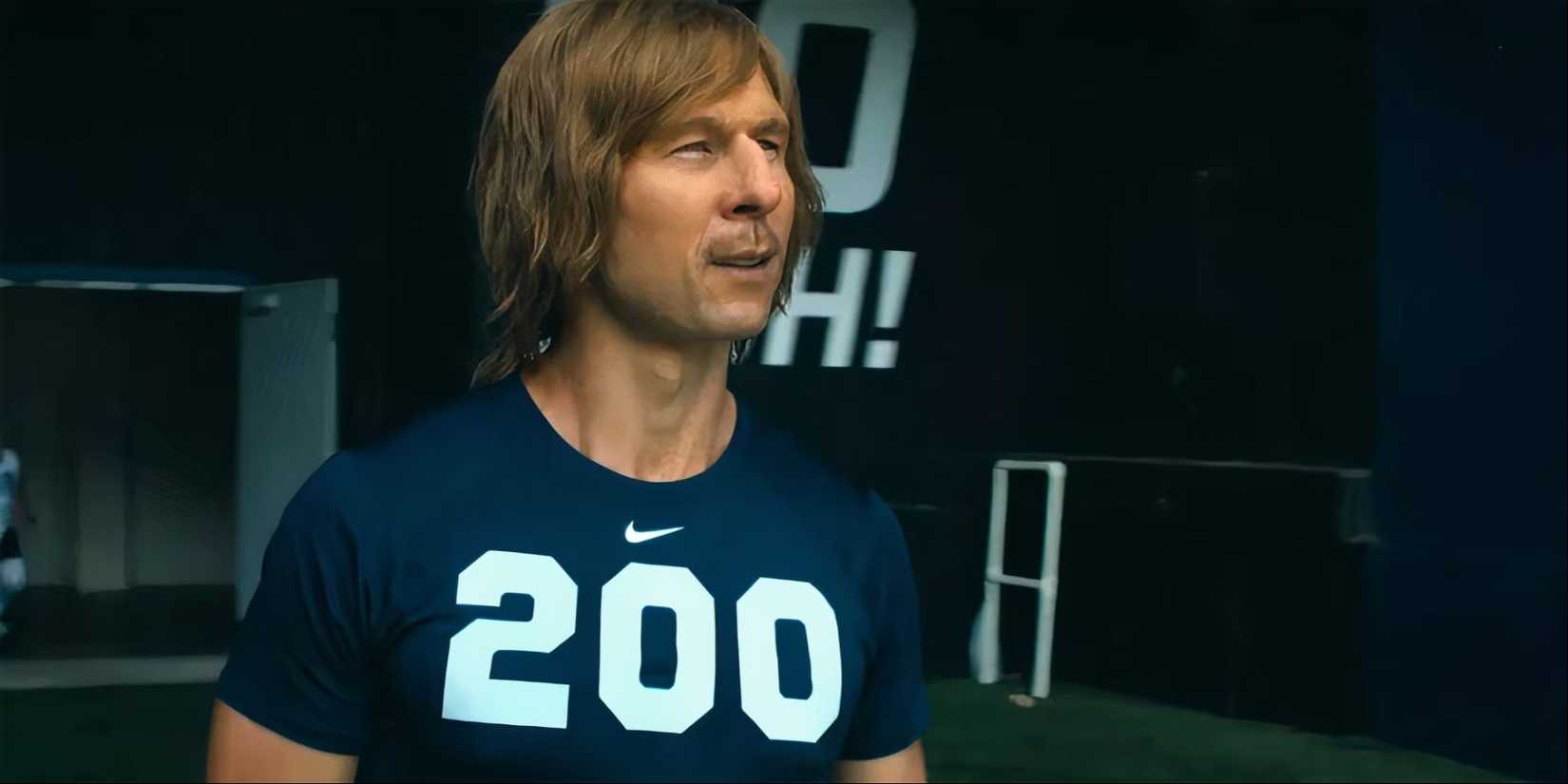 Glen Powell as Chad Powers wearing a jersey with the number "200" on it and looking ahead in Chad Powers.