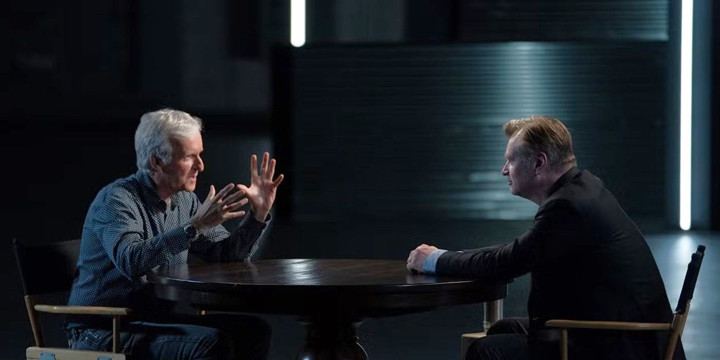 James Cameron, across a table from another person, talking in James Cameron's Story of Science Fiction.