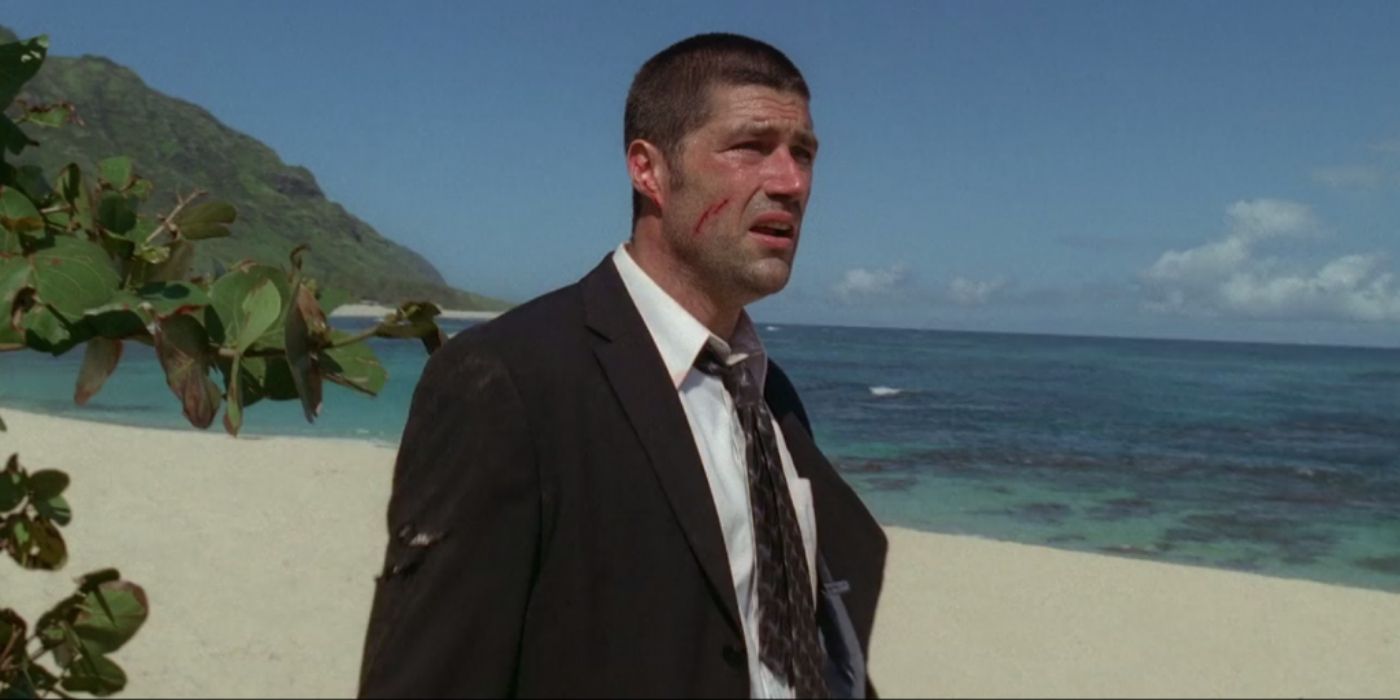 Jack looking out in despair while standing on a beach in the pilot episode of Lost (2004).